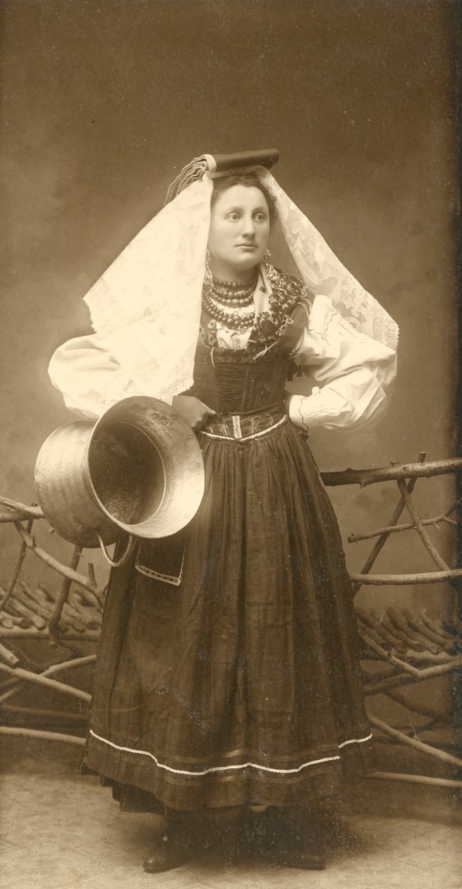 Woman wearing traditional costume and holding copper container, Abruzzo, Italy by Italian Photographer