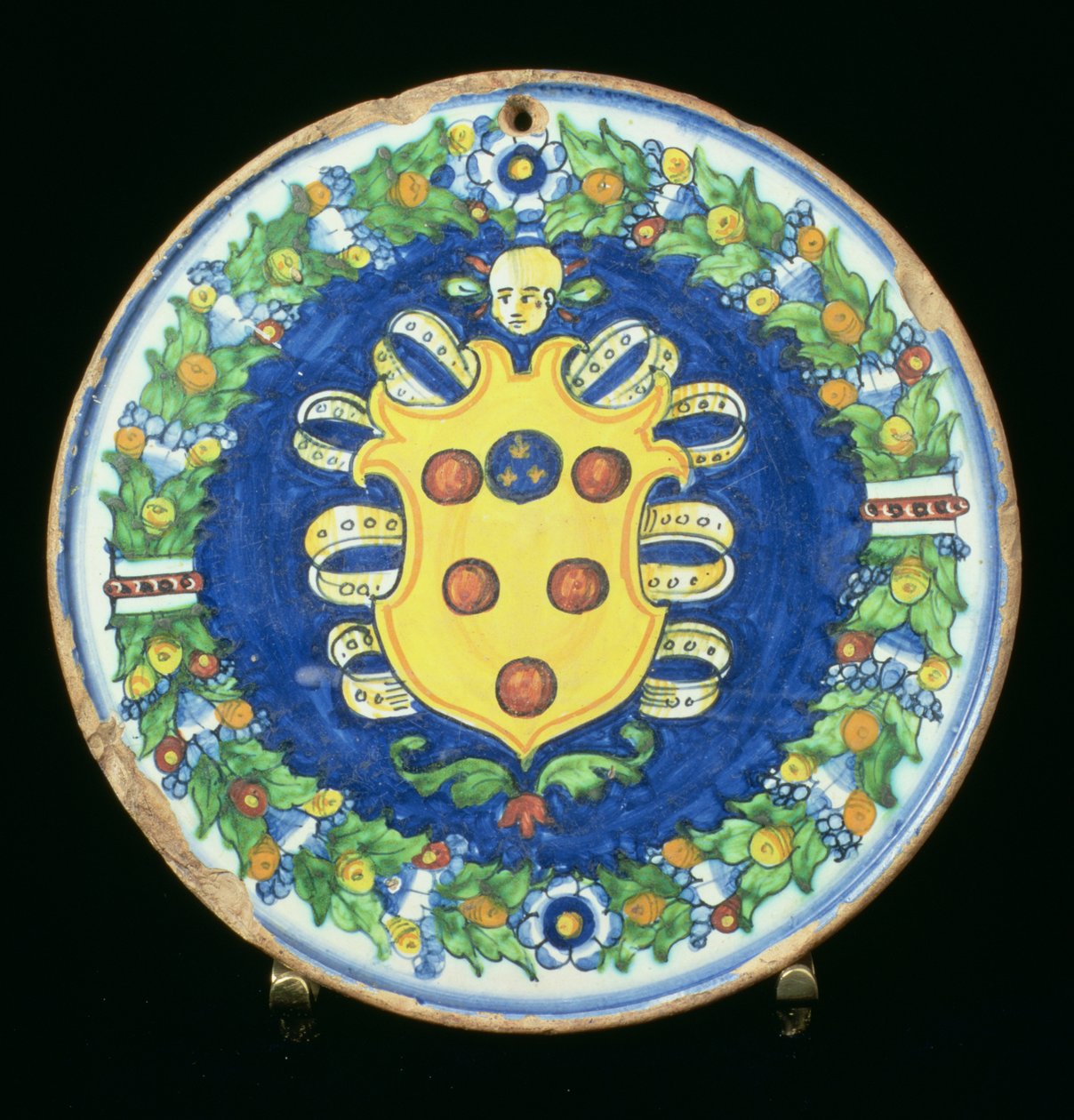 Maiolica plate bearing the Medici coat of arms with a border of foliage and fruit, Italian, 16th century by Italian School