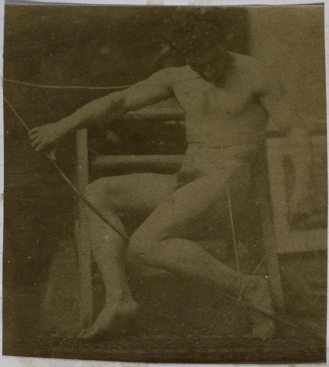 Study of a male nude model, sitting on a step, seen from the front with rope and bow on lap, in the studio of Jacques de Lalaing by Jacques Lalaing (attributed to)