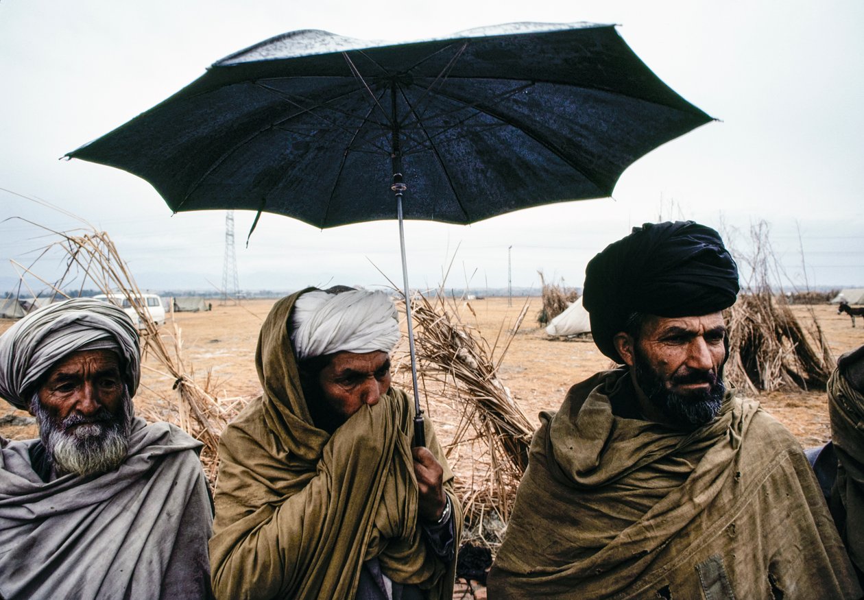 Pakistani Men with an Umbrella and Traditional Garments by James L Stanfield