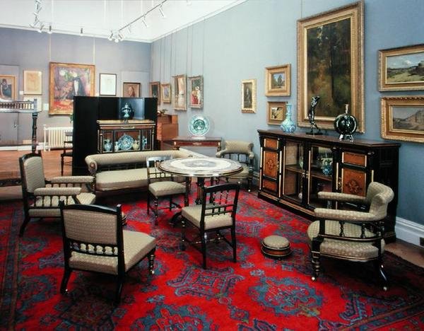 Suite comprising a cabinet, centre table, sofa, pair of side chairs, pair of armchairs, nursing chair, armchair and card table, 1880s by James Lamb of Manchester