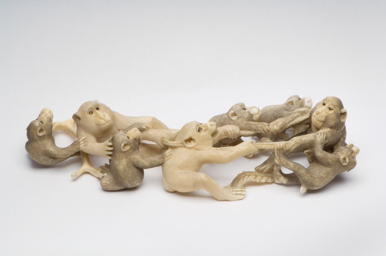 Okimono carved as eight Japanese Macaque monkeys engaged in neck wrestling by Japanese School