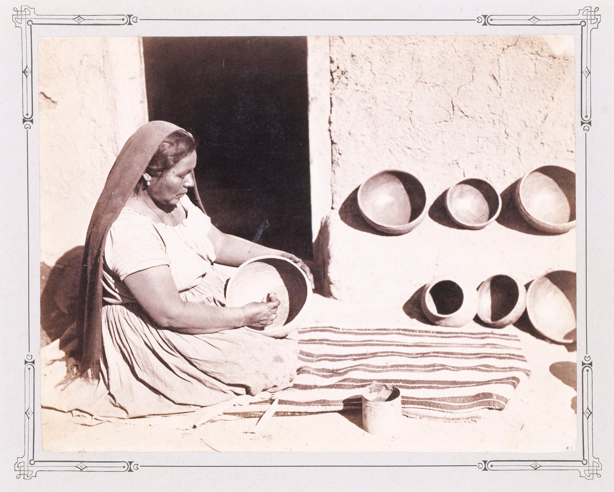 Woman Polishing Pottery by John K. Hillers