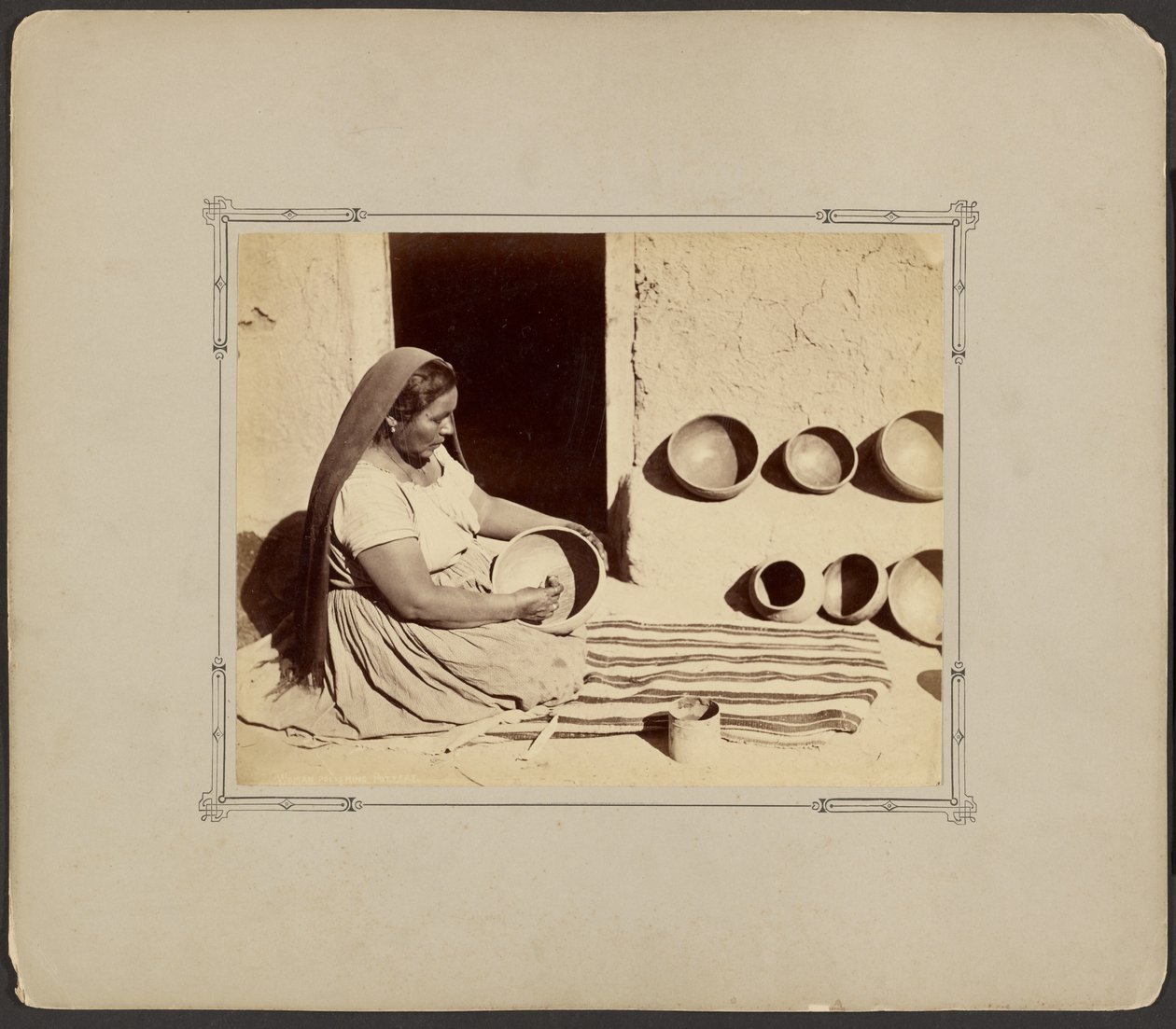 Woman Polishing Pottery by John K. Hillers