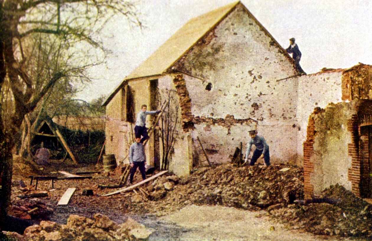 Four men working on a house that was severely damaged during the Battle of the Marne east of Paris, September 1914 by Jules Gervais Courtellemont