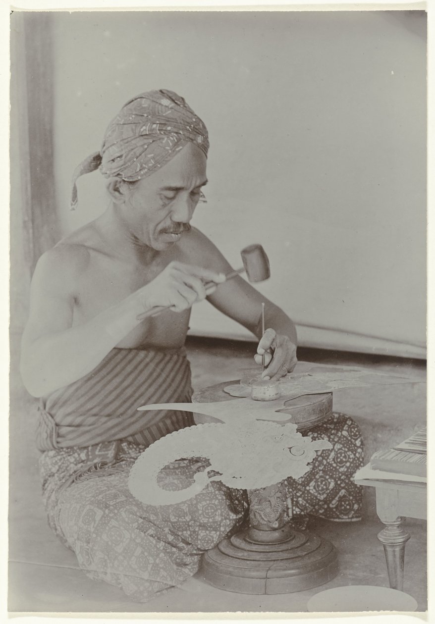 Javanese Man Creating a Human-Like Figure with Hammer and Instruments by Kassian Cephas