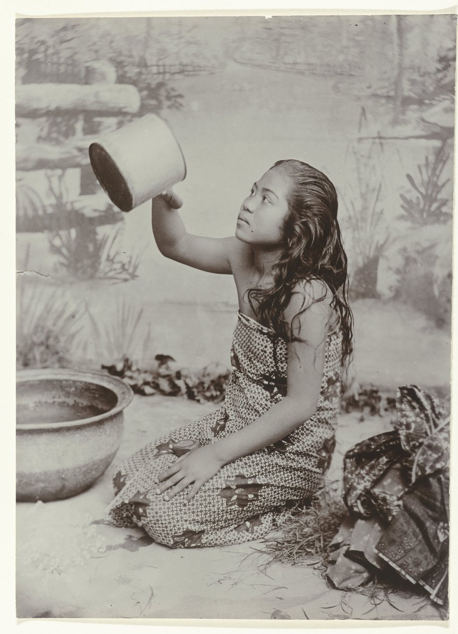 Studio portrait of a young Javanese washing woman by Kassian Cephas