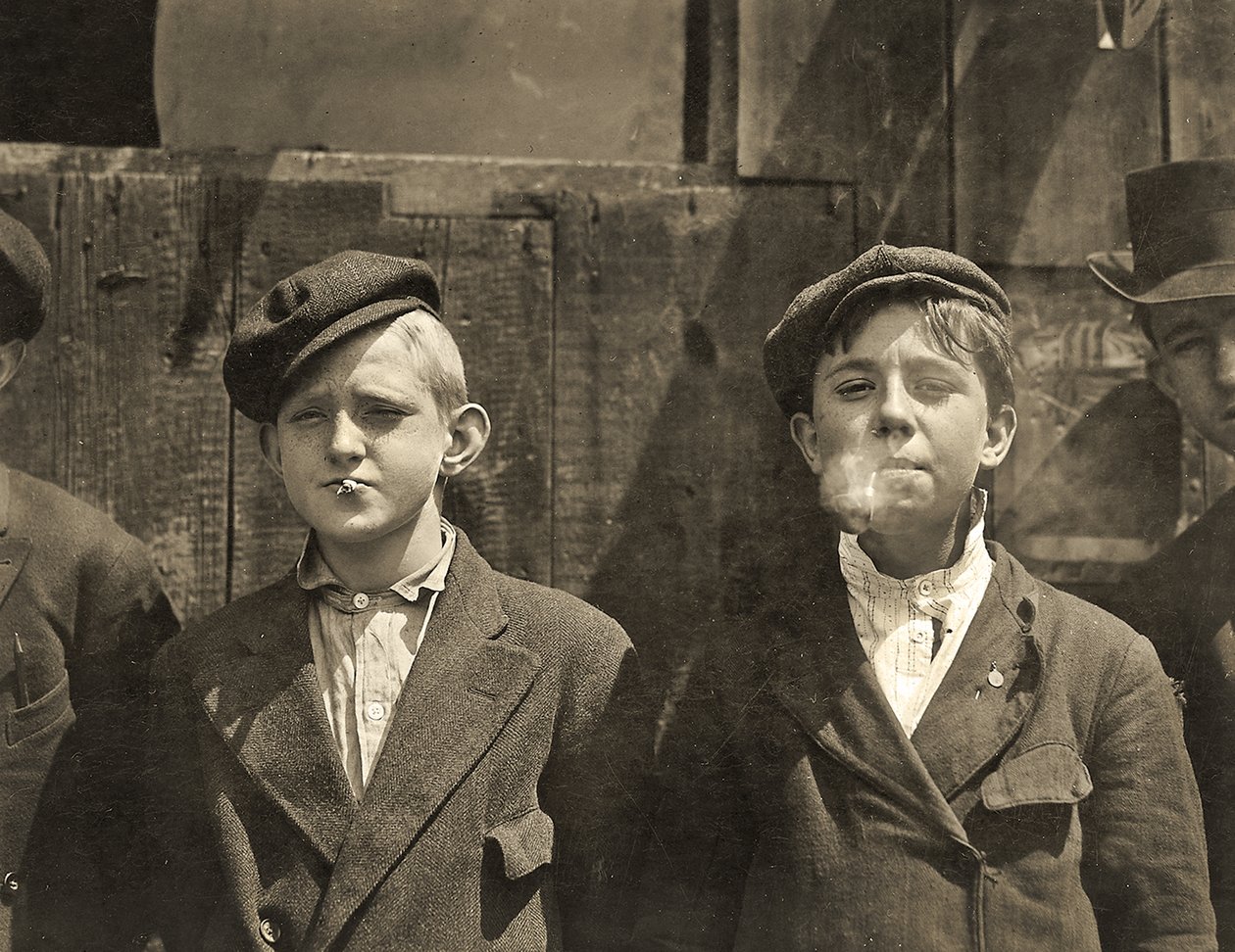 Newsboys having a cigarette break, St. Louis, Missouri. 1910 by Lewis Wickes Hine