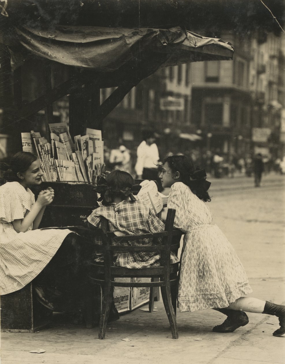 Three Young Girls Working at a Newspaper Stand on Canal Street in New York City by Lewis Wickes Hine