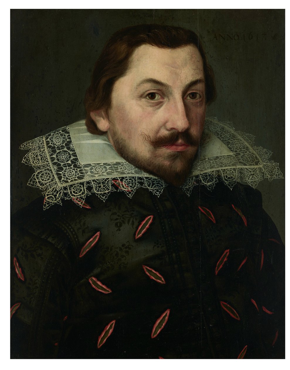 Portrait of a man, bust-length, in a black slashed silk doublet with a ...