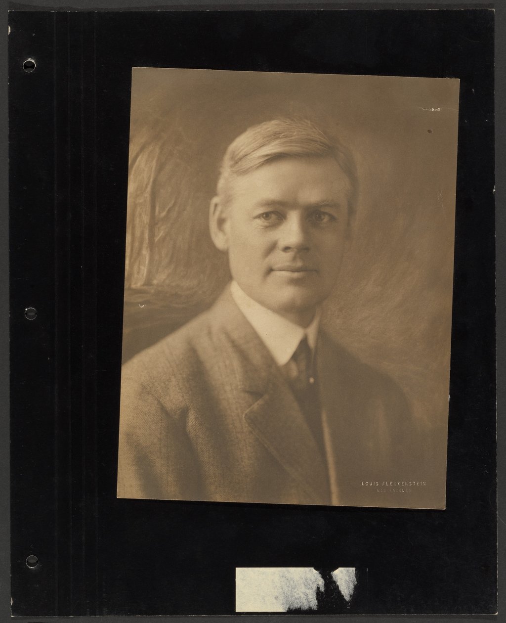 Portrait of a Man Seated Before Painted Backdrop by Louis Fleckenstein