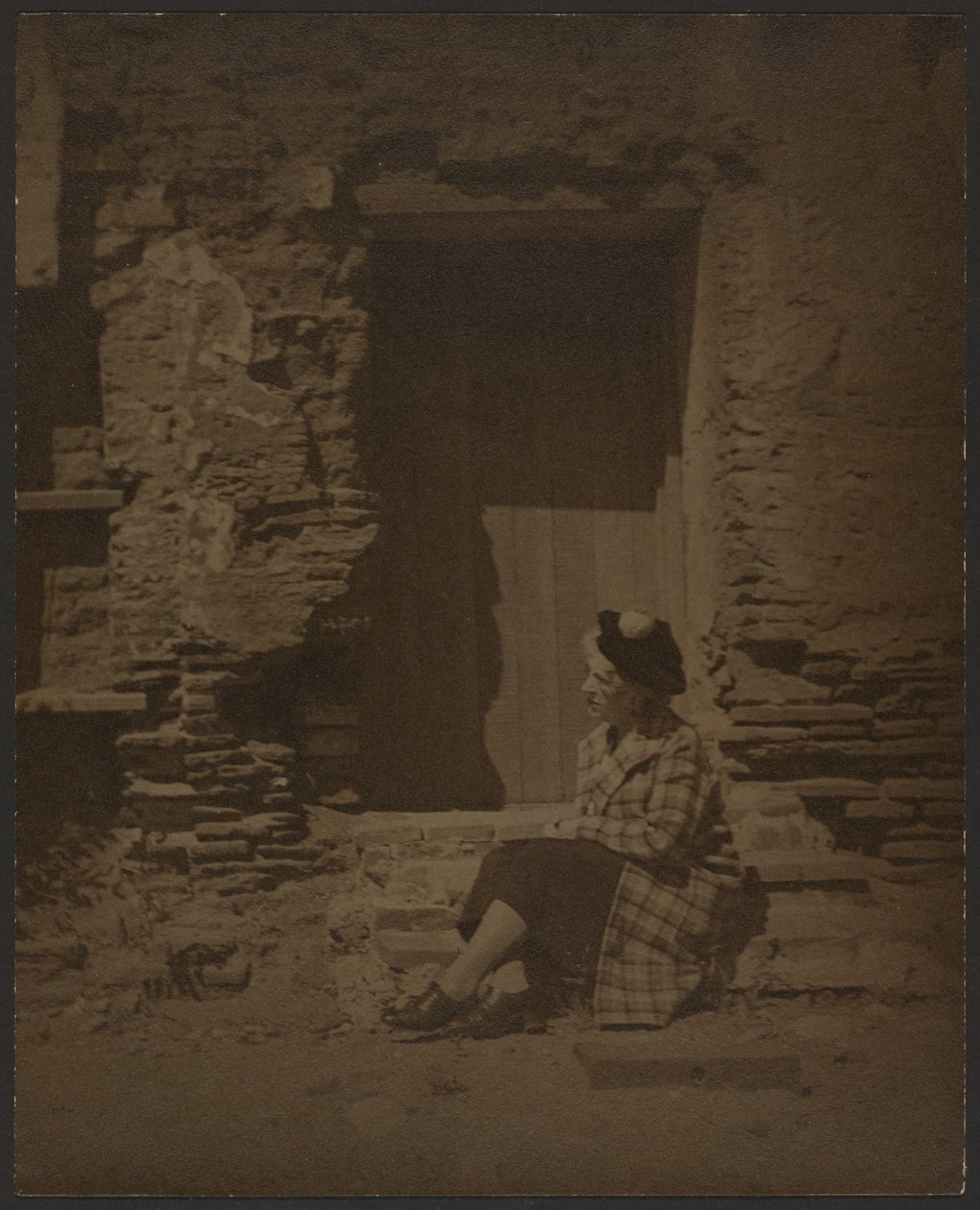 Woman Seated Before Deteriorating Building by Louis Fleckenstein
