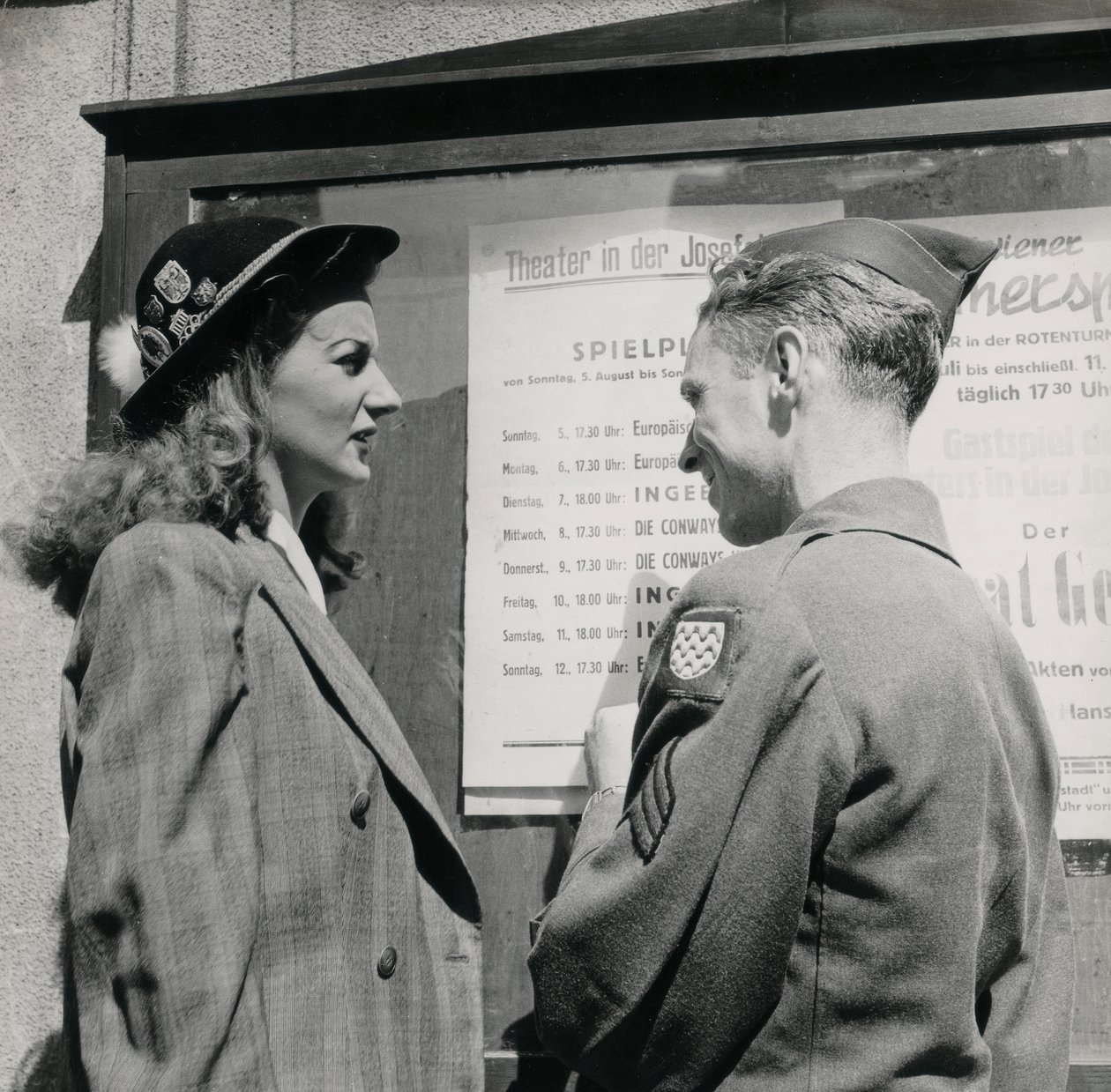 Soldier with a young woman in front of a Viennese theater poster by Luigi Leoni