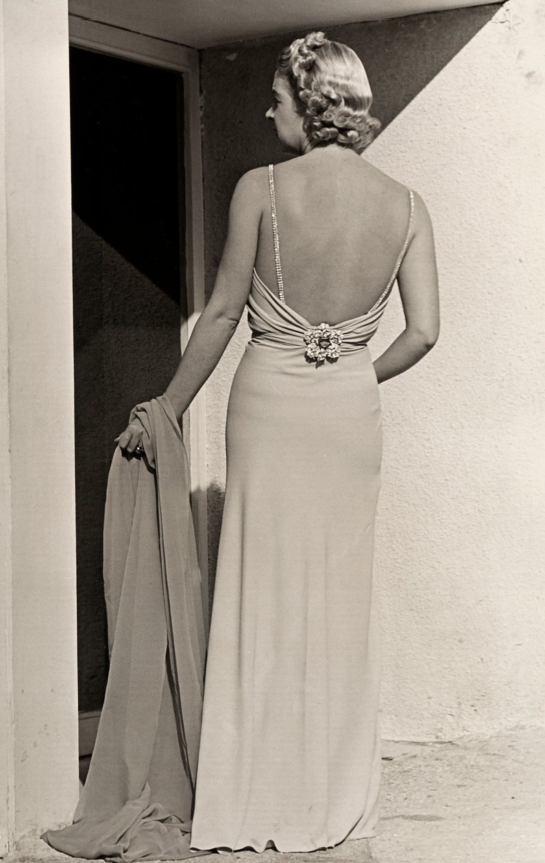 Model seen from the back wears evening dress from the couture house 