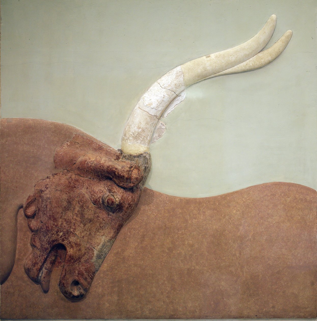 Minoan Art. Fragment of plaster relief fresco showing a hunted bull by Minoan