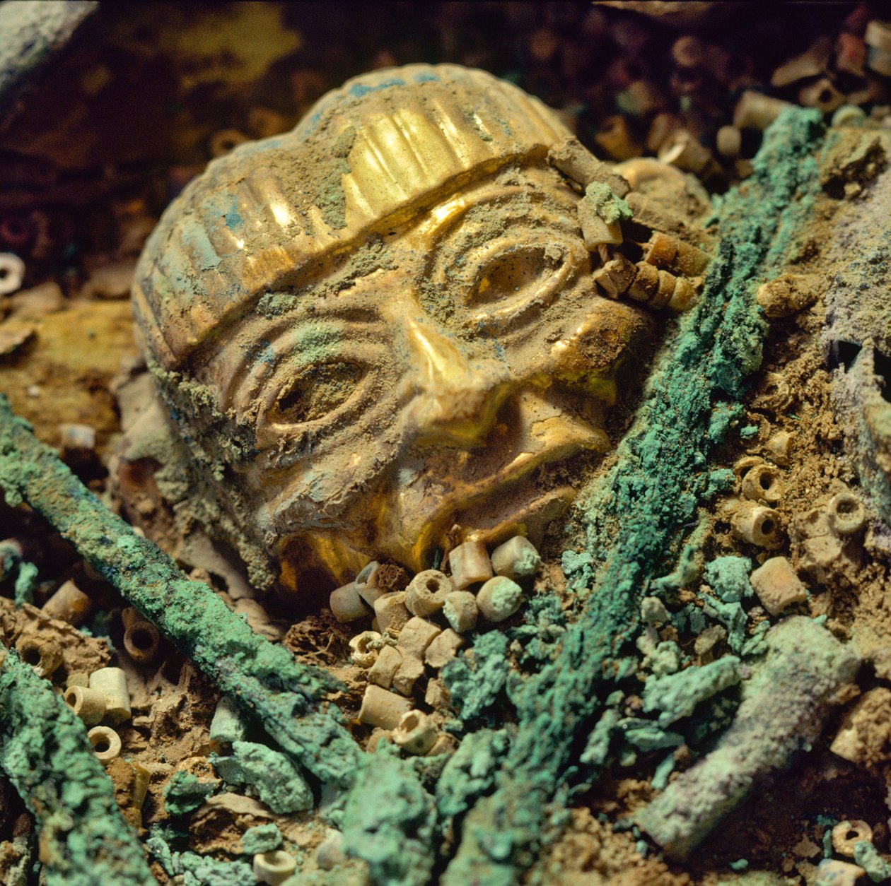 Gold head bead buried in the Moche royal tomb of the Old Lord of Sipan by Nathan Benn