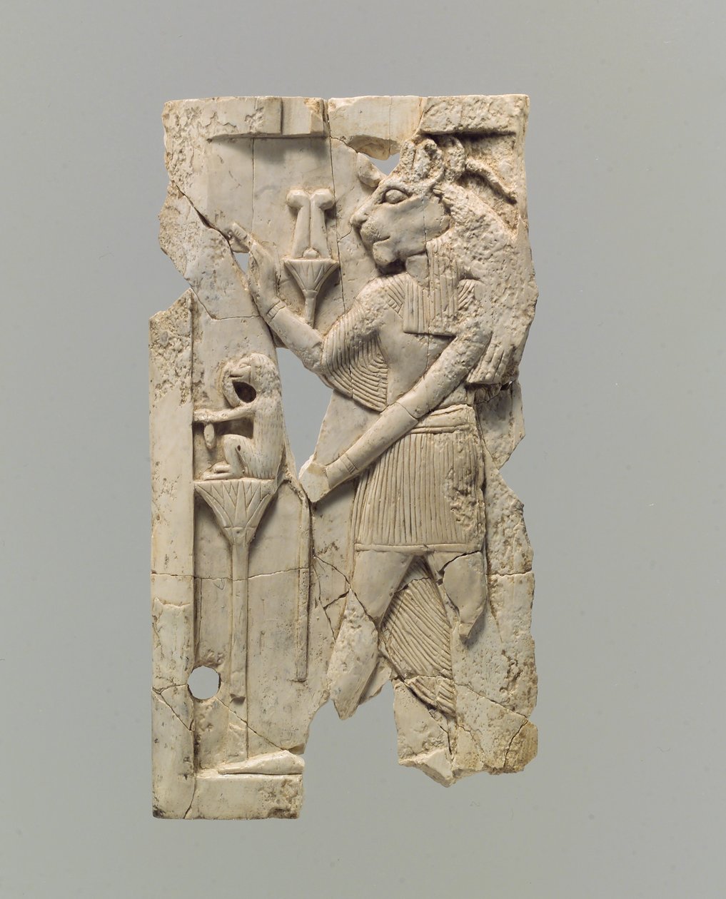 Furniture plaque carved in relief with lion-headed figure by Neo Assyrian