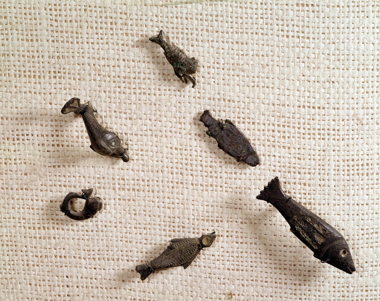 Christian antiquity: fibulae and metal jewelry in the shape of fish. National Museum of Archeology, Saint Germain en Laye by Paleo Christian Paleo Christian