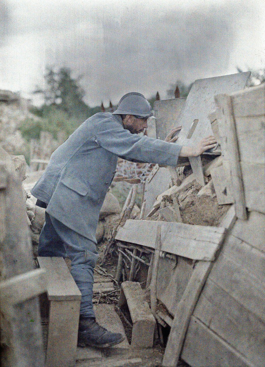 A French soldier in the Army lookout 26 viewing the area in front of him through a protective metal shield, Eglingen, Department Haut-Rhin, Alsace, France, June 26, 1917 by Paul Castelnau