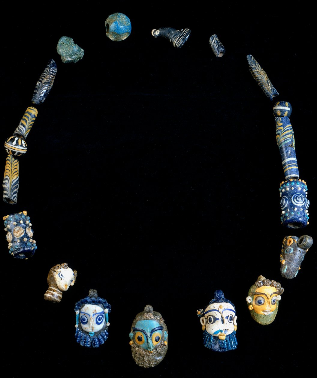 Necklace in glass paste with pendants depicting bearded heads, originally from Olbia, National Archeological Museum of Cagliari by Phoenician Phoenician