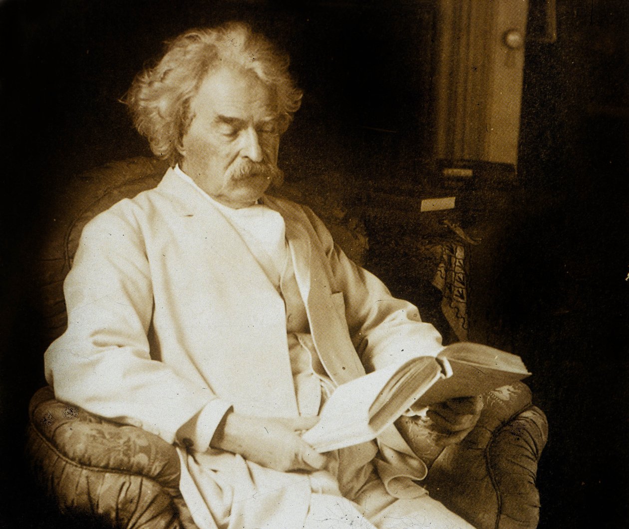Mark Twain (Samuel Langhorne Clemens) Reading by Photographer American