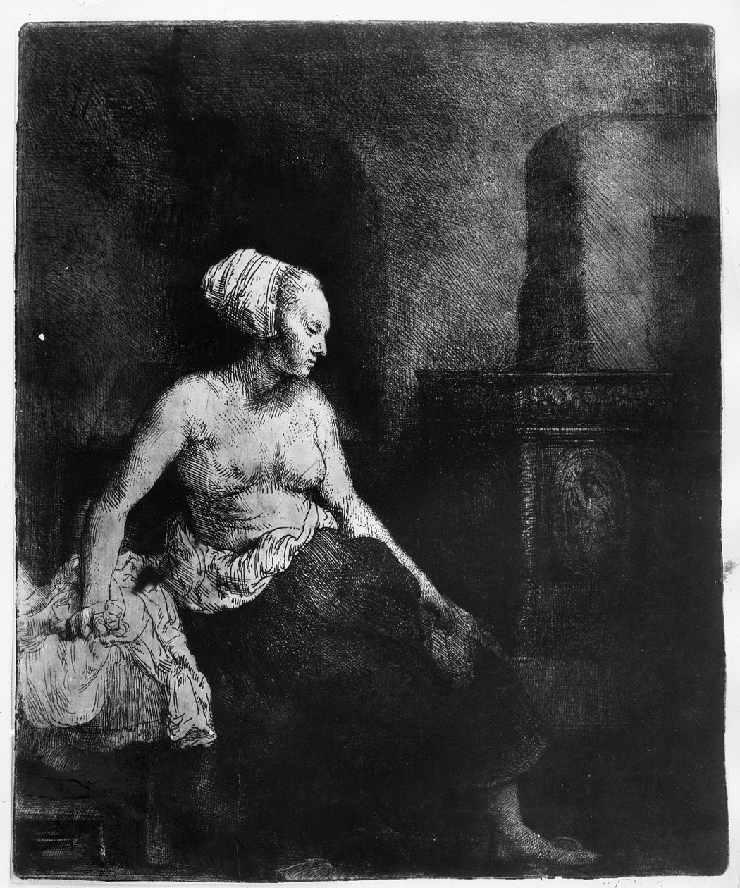 Woman Sitting Half-Dressed Beside a Stove by Rembrandt van Rijn