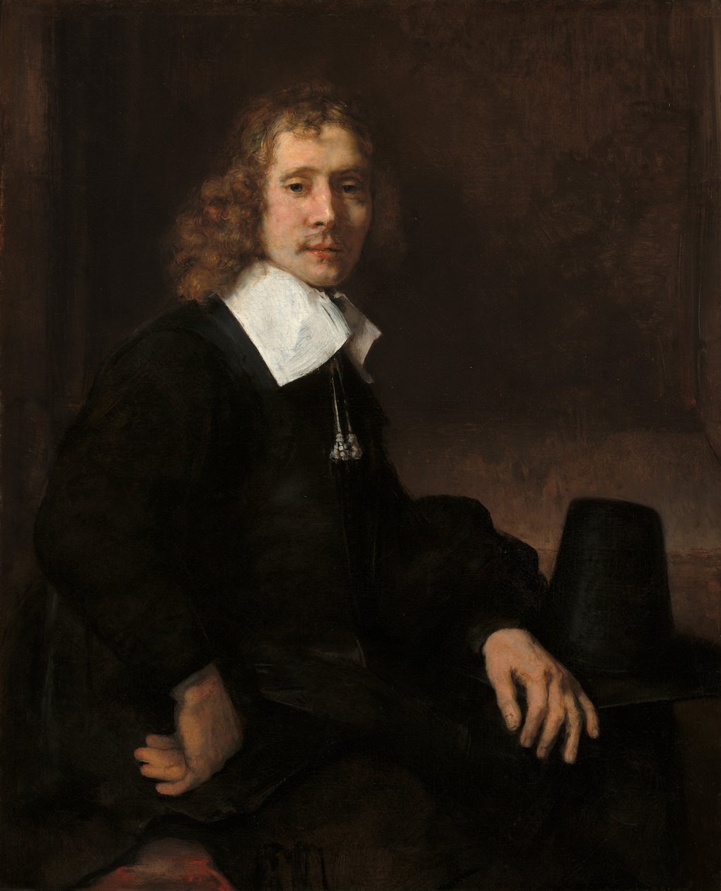 A Young Man Seated at a Table by Rembrandt van Rijn