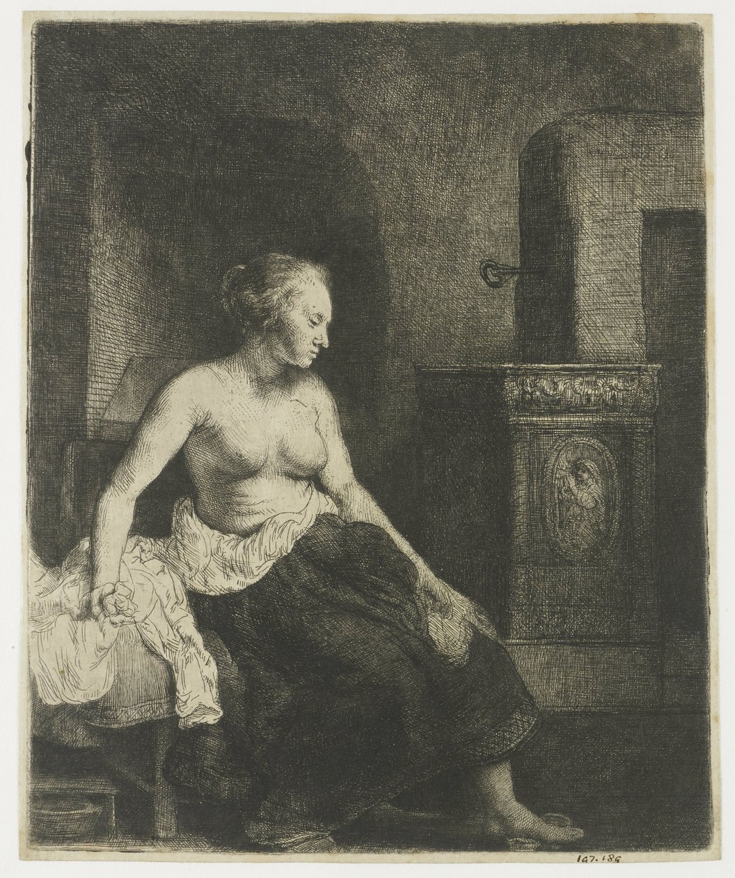 Woman sitting half dressed beside a stove by Rembrandt van Rijn