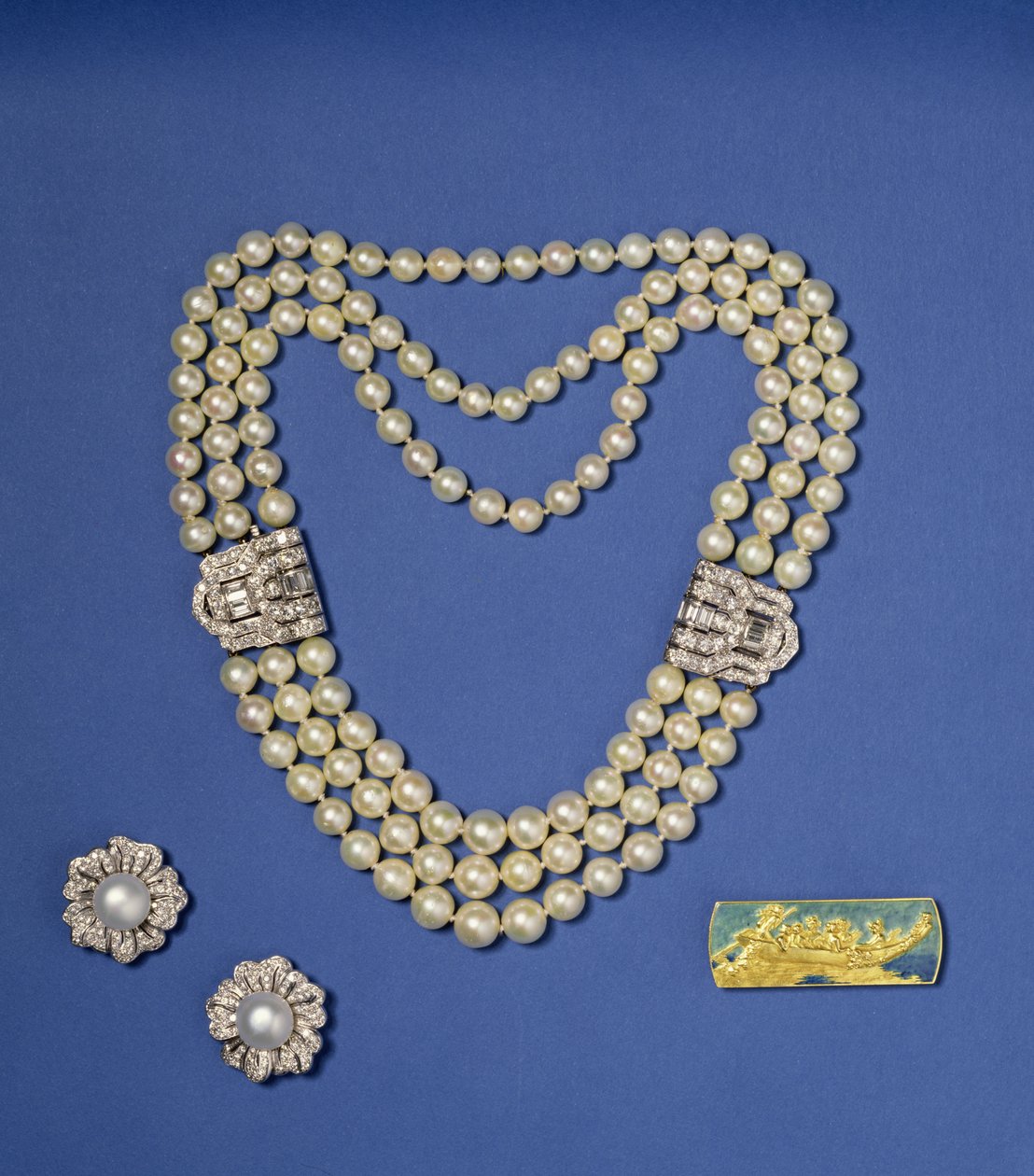 Selection of pearl jewellery: three-row pearl necklace with diamond clips; bouton shaped Southsea cultured pearl earrings; gold and enamel brooch by Lalique, c.1900 by Rene Jules Lalique