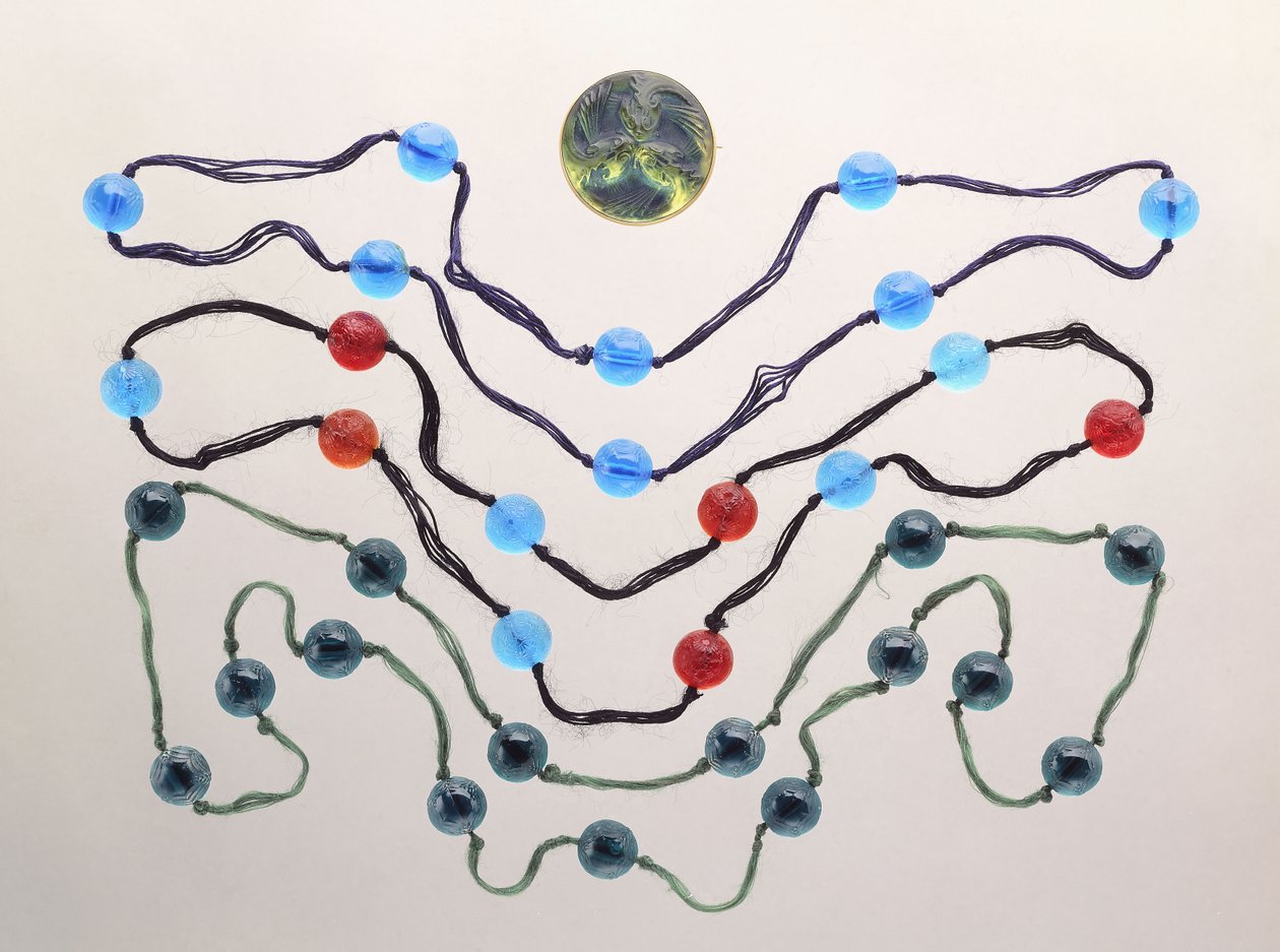 Three Strands of Coloured Glass and a Moulded Frosted Glass Brooch (