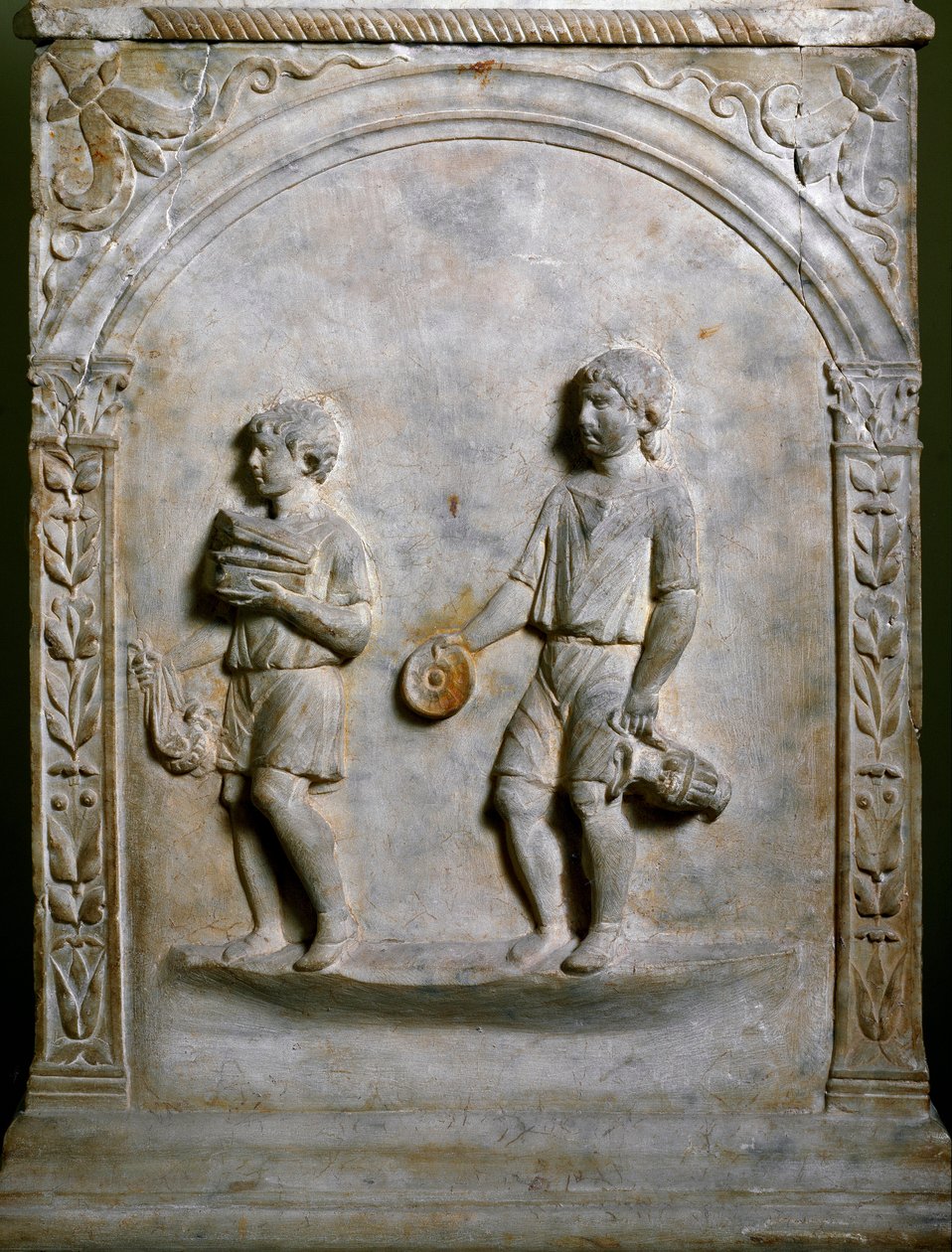 Burial altar depicts two servants carrying objects for sacrifice. Low relief by Roman Roman