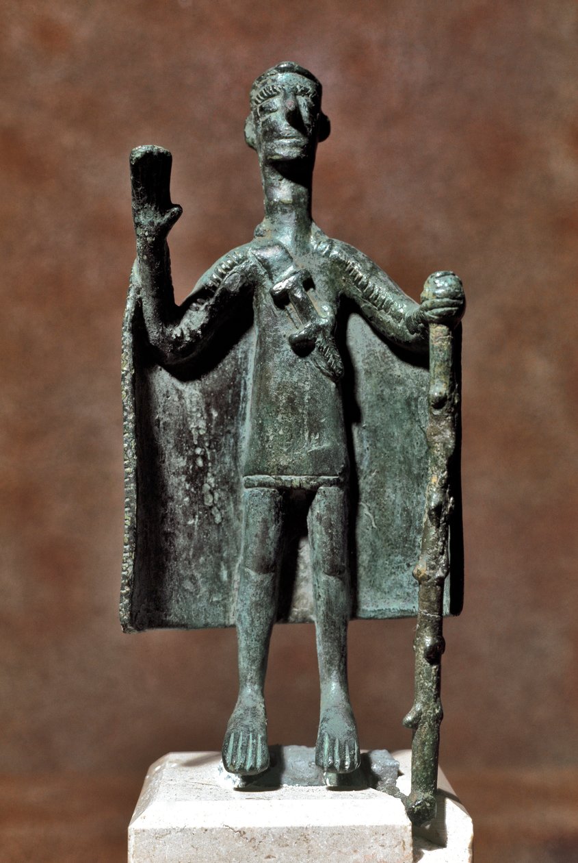 Nuragic culture: bronze statuette of traveller holding a stick and covered with a cape. Cagliari, Museo Nazionale Archeologico, Sardinia, Italy by Sardinia Nuragic Civilization