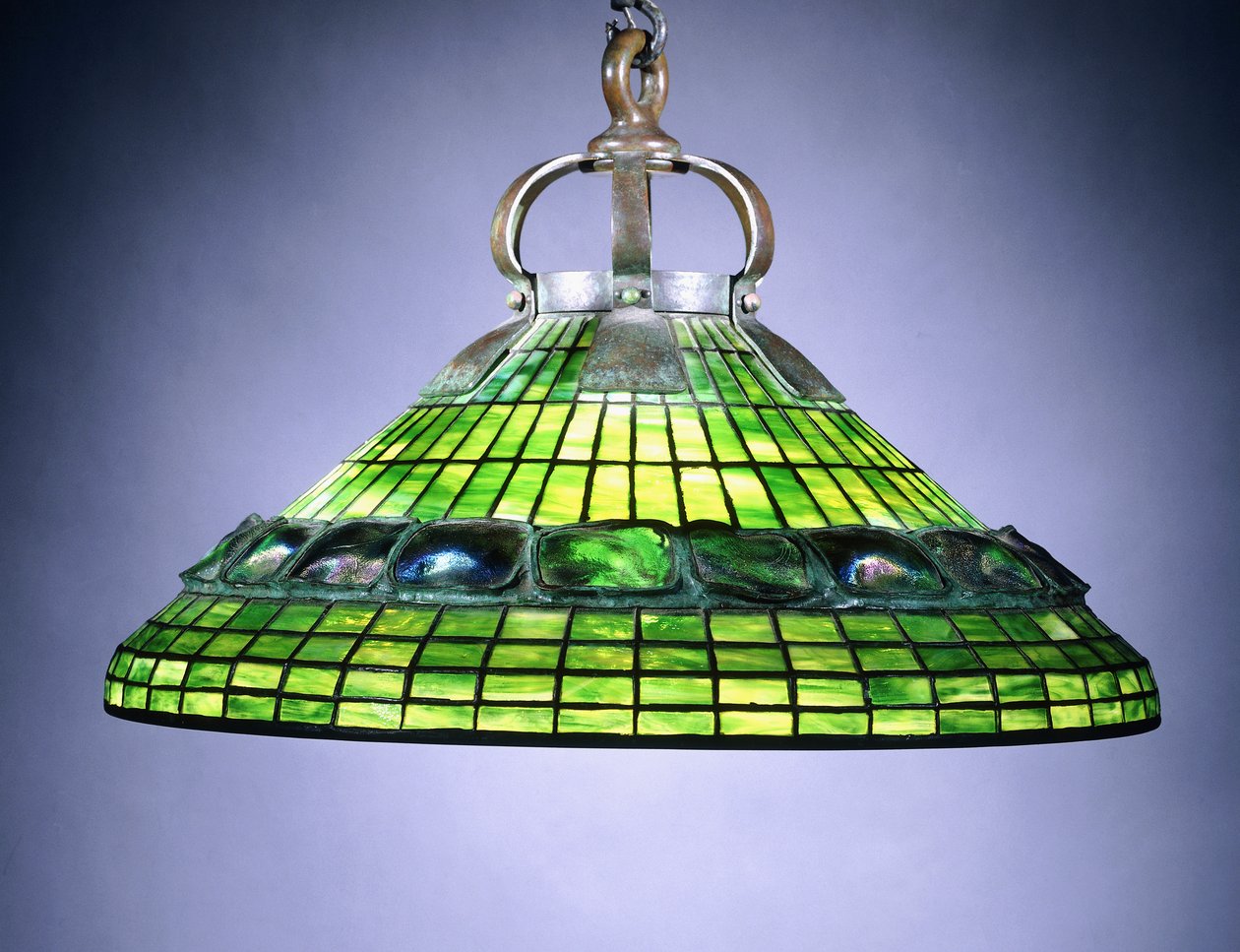 A leaded glass turtleback tile and bronze chandelier by School American