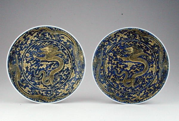 A pair of underglaze blue & yellow dragon dishes by School Chinese
