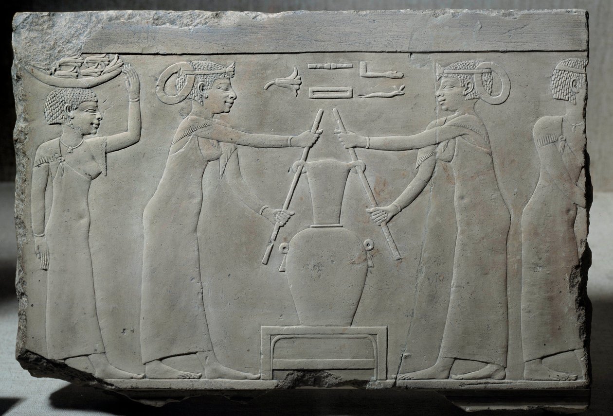 Low limestone relief representing women pressing lily flowers to extract the essence called “lirinon extraction” around 500-400 BC (Egyptian antiquity) by School Egyptian