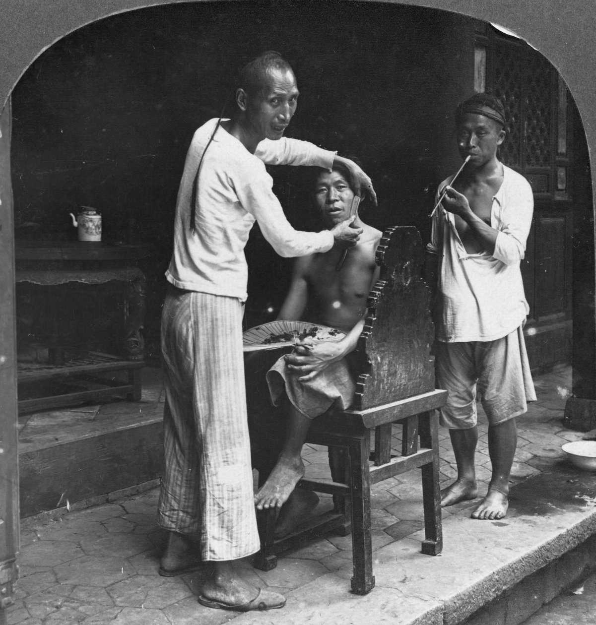 A Chinese Barber at Bhamo, Burma, 1908 by Stereo Travel Co