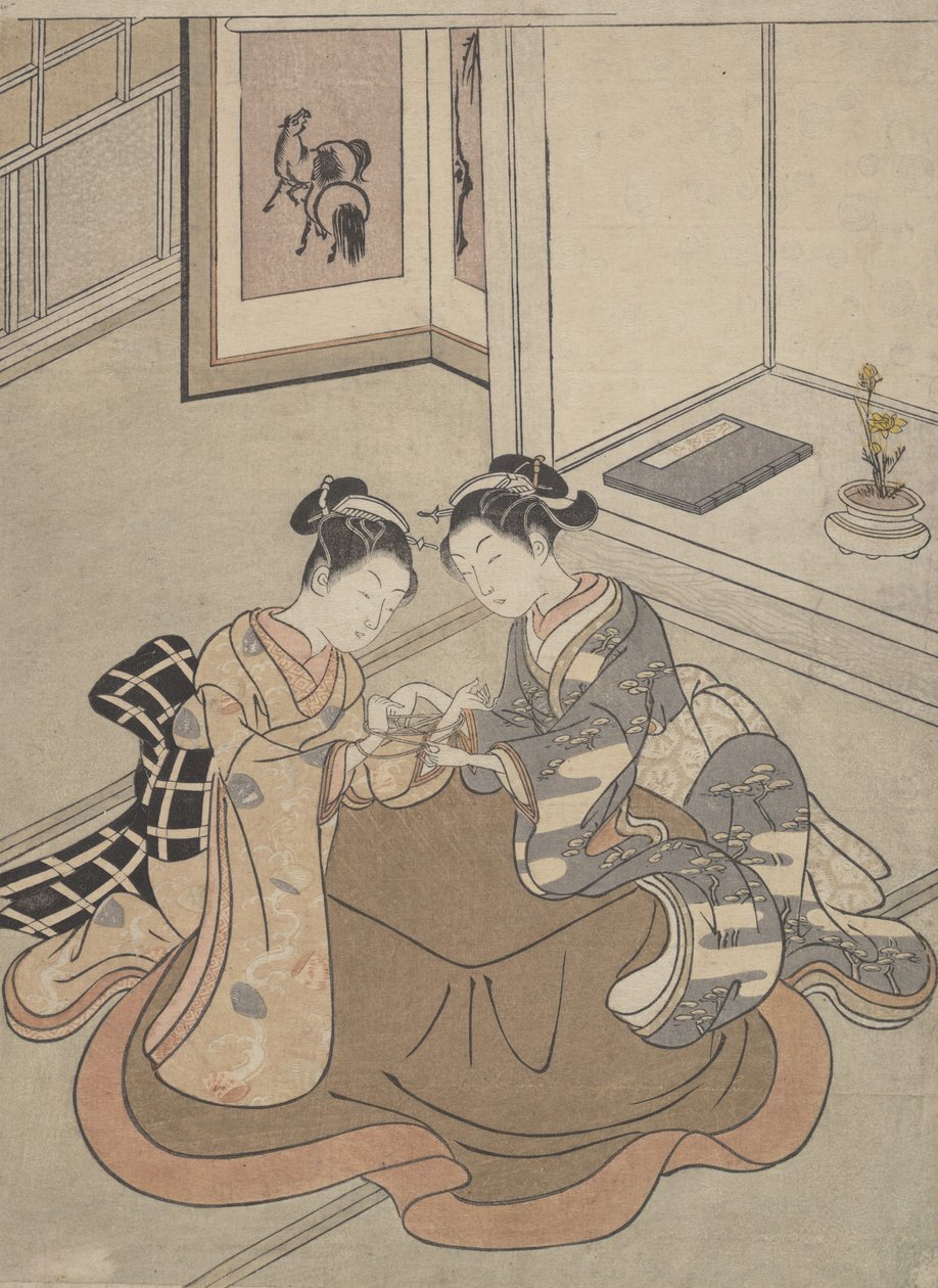 Two Young Women Seated by a Kotatsu Playing Cat