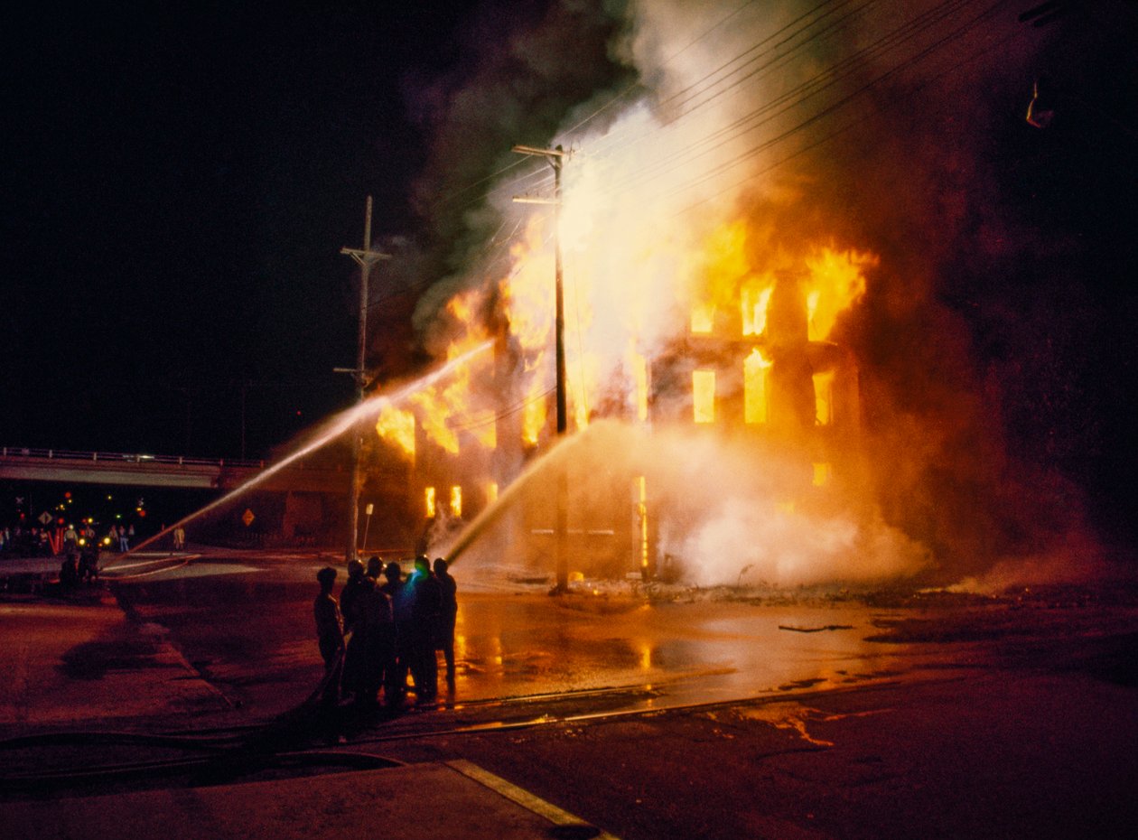 An urban building engulfed in fire and flames at night in Kansas City ...
