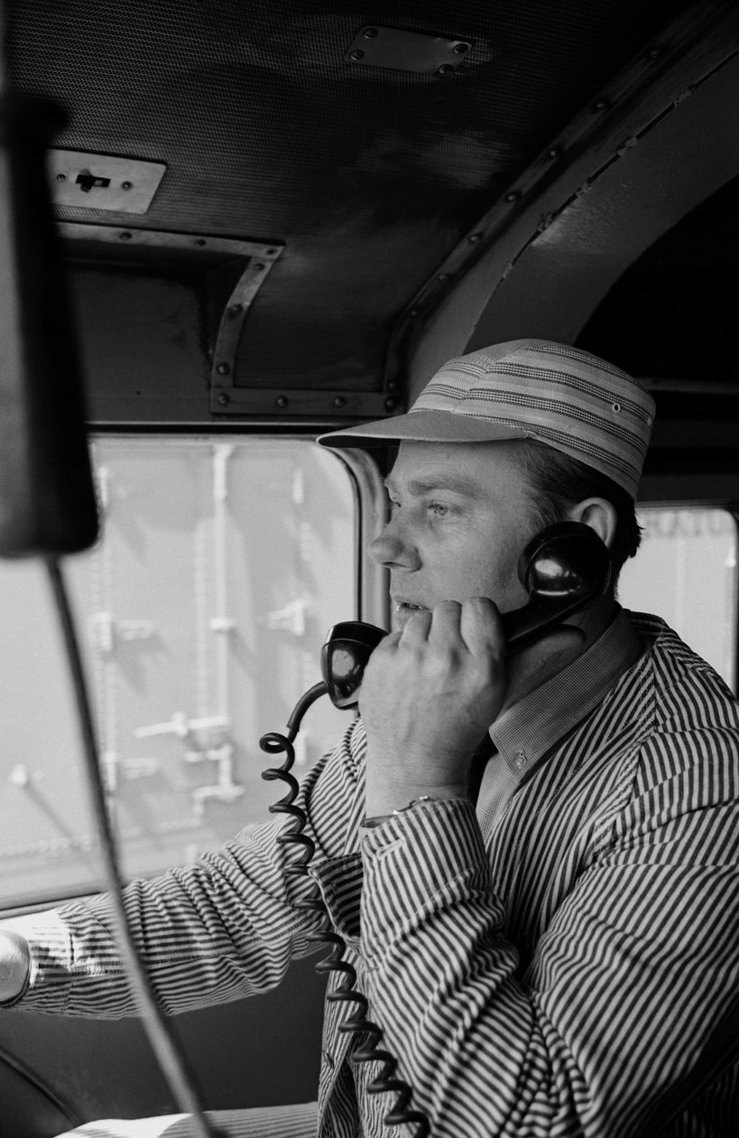 Charles Brockman, engineer of the Great Northern Railroad, speaks on radio phone from train by Ted Spiegel