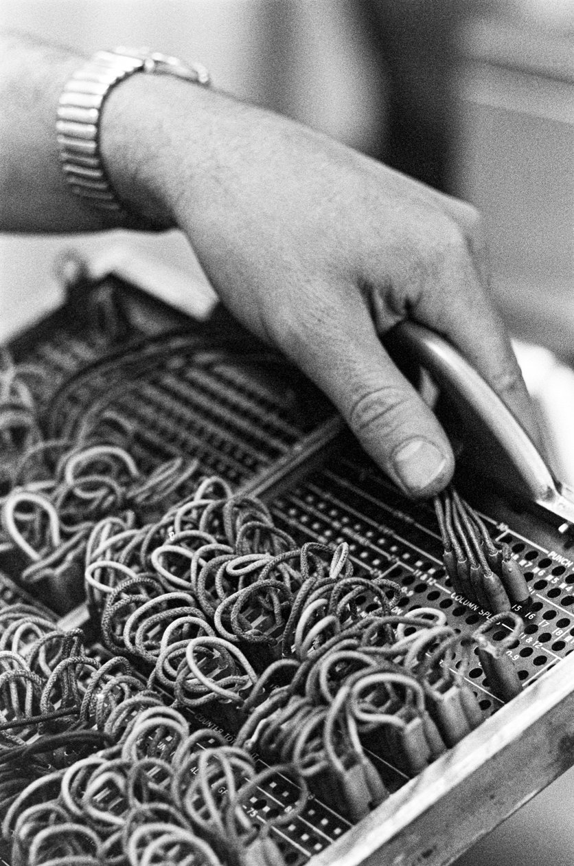 Computer operator Don Murray working with IBM early digital computer that uses punch cards by Ted Spiegel