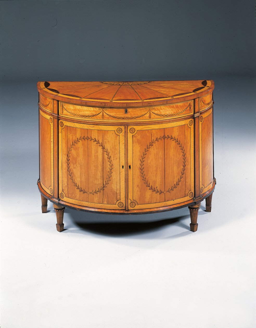 George III marquetry demi-lune commode, c.1760-79 by Thomas (attr.to) Chippendale