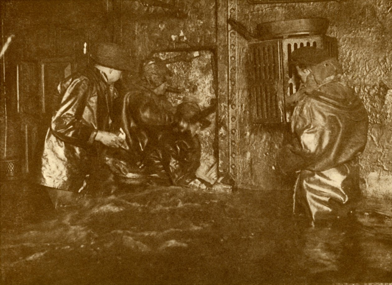 Divers Plugging A Leak During Salvage Operations Waist-Deep In Water On the Lower Decks Of The Germ by Unbekannt