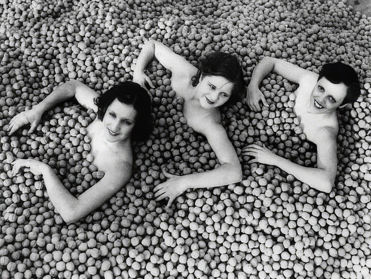 Three Young Women Bathing in a Sea of Walnuts by Unbekannt