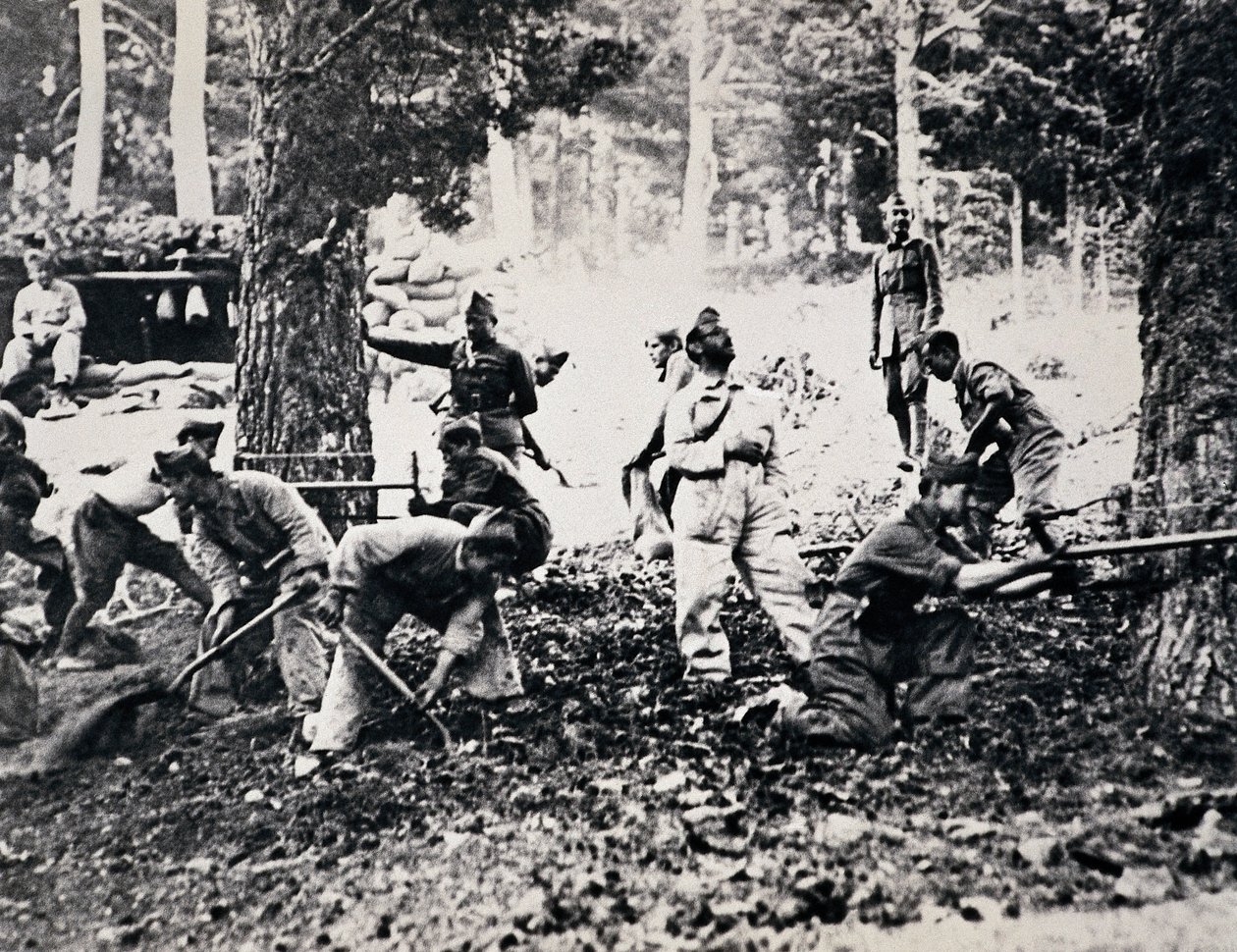 Legionnaires on the front of the Sierra cutting pine trees and filling the bags to make shelters against enemy planes by Unbekannt