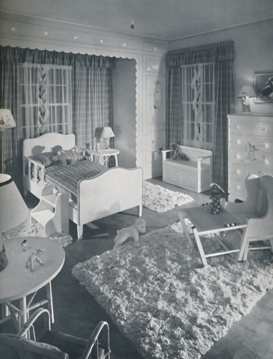 Nursery by W. & J. Sloane, with cream-coloured furniture and shaggy white rugs on a blue painted floor by Unbekannt