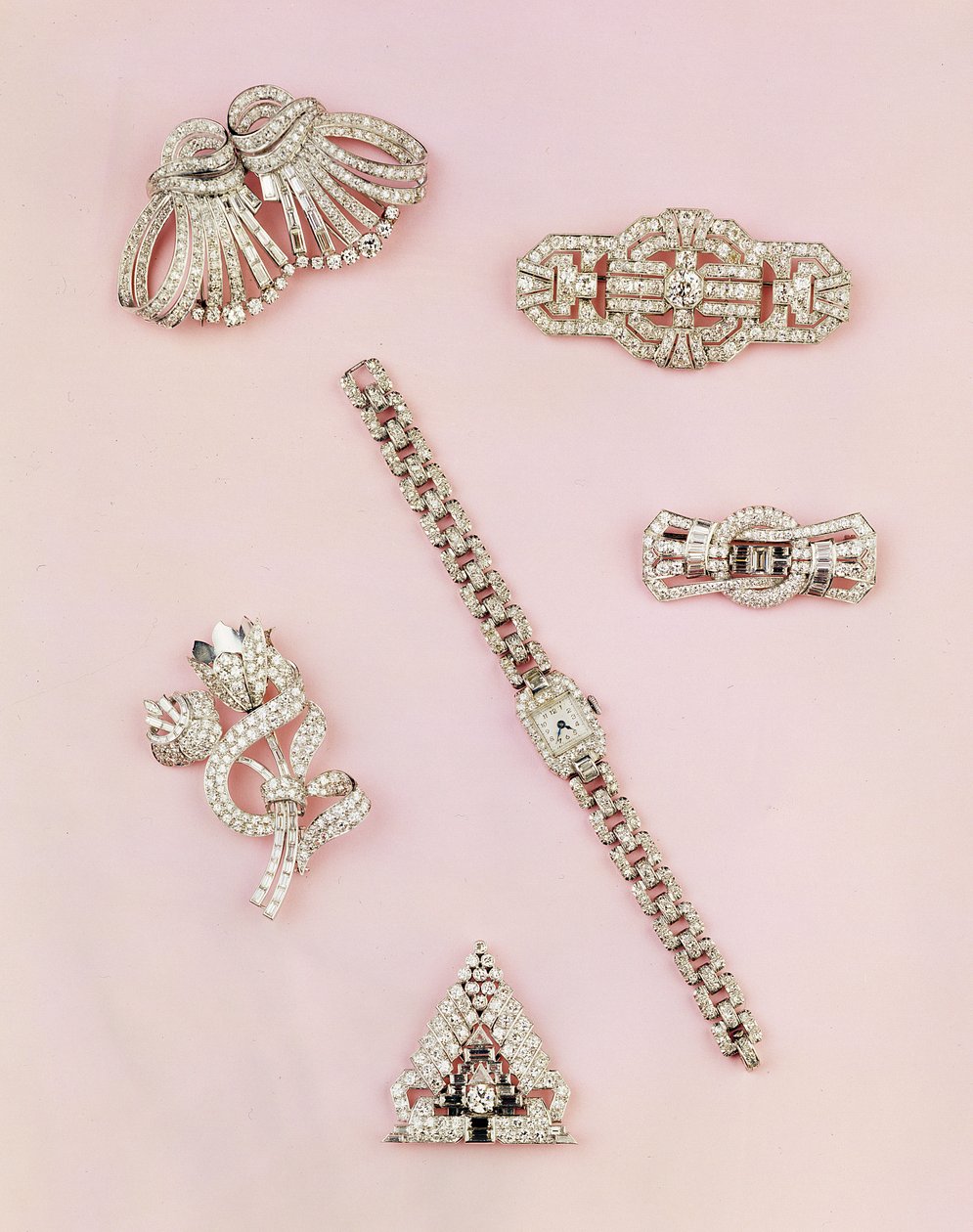 Selection of diamond jewellery: baguette and marquise-shaped diamond spray brooch; Art Deco diamond clip; panel diamond brooch; lady