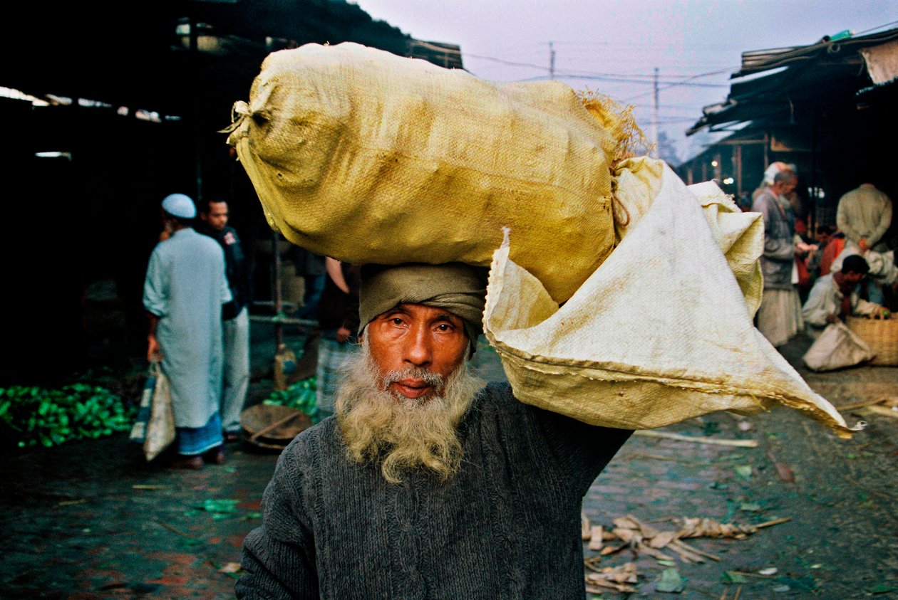Portrait of a Vegetable Seller. Abdus Samad Buys Vegetables in the Wholesale Market and Sells Them in the Street. Nirala Kacha Bazar, Khulna, Bangladesh by Unbekannt Unbekannt