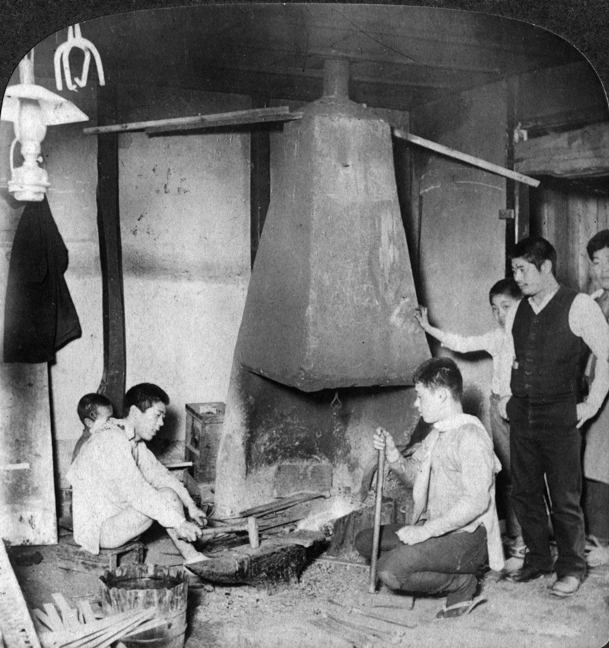 A Japanese blacksmith at his forge, Yokohama, Japan, 1904 by Underwood and Underwood