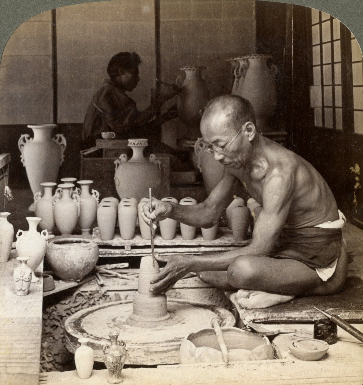 A Potter and His Wheel, Fashioning a Vase of Awata Porcelain, Kinkosan Works, Kyoto, Japan, 1904 by Underwood and Underwood