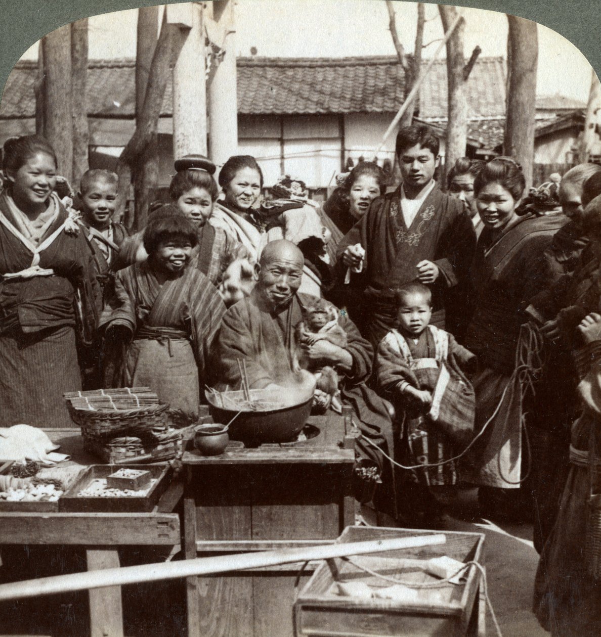 A street performer with a monkey amusing the crowd, Kobe, Japan, 1896 by Underwood and Underwood